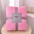 Detail of folded pink flannel blanket with vertical stripes and elegant ribbon packaging - Pretty Pink