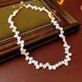 Baroque freshwater pearl necklace with gold clasp on green velvet display tray - Titanium Steel Freshwater Pearl Beaded Necklace