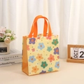 Yellow non-woven tote bag with colorful floral print and sturdy orange handles - Yellow Floral / 36x32x12cm