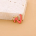 Pink enamel letter Z pendant with gold plating on a textured stone display - Enamel Letter-V