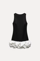 Detail view of the black sleeveless top and white ruffled hem on the bodycon dress - XS / Black & White