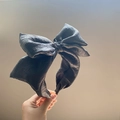 Elegant black seersucker oversized bow headband with textured fabric for women - Black