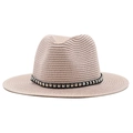 Detail of light beige straw fedora hat featuring a black band with silver square studs - Nude Pink