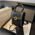 Vertical black leather crossbody phone bag with gold twist lock and metal rivets - Black