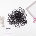 Set of black high-elastic hair ties for girls on white textured background - 2cm Nylon Black