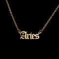 Macro view of Aries gothic pendant necklace in gold-plated stainless steel on black background - Aries - Gold