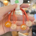 Close-up of orange candy color elastic hair ties with glitter resin ball beads - 2-Piece Set / Orange