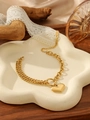 Detailed close-up of gold heart pendant bracelet with double chain on a white tray - Heart Herringbone Chain Bracelet (Gold)