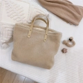 Detailed shot of beige faux shearling tote with brown PU handles and rivet accents - Beige Apricot