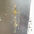 Detail of golden crystal suncatcher showing geometric frame with moon and star charms - 49-51cm / Gold Alloy + Citrine