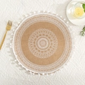 Detail of round jute placemat featuring white mandala lace embroidery and pompom tassel trim - White Pom-poms Pattern 2