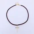 Detail of a dark brown cord necklace featuring a gold cross pendant and lobster clasp - Coffee