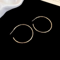 Detail of minimalist gold hoop earrings with hammered metal texture on black silk background - 4cm / Silver Needle / Gold