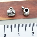 Silver alloy beads with embossed floral patterns, approx 0.8cm size on wood background - Embossed Pattern Bail