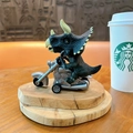 Detailed green triceratops riding a vintage silver pull-back motorcycle toy - Inertial Motorcycle Dinosaur - Triangle Brown