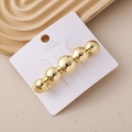 Detailed view of a gold hair clip with five polished spherical beads on white card - Polished Ball Chain Gold