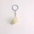 Detailed view of bubble tea keychain with realistic resin liquid and silver metal ring - Beige