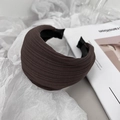 Detailed texture of a wide brown pleated fabric headband with chic retro French design - Brown
