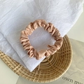 Elegant champagne gold satin scrunchie with pleated texture and soft metallic silk sheen - Dark Brown