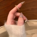 Golden bow pearl ring with rhinestones shown on hand over a warm wooden background - J5147-Gold Rhinestone