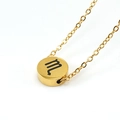 Macro detail of golden round pendant necklace featuring engraved black Scorpio zodiac symbol - 18K Gold / Scorpio