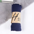Solid navy blue linen scarf rolled with paper sleeve on grey faux fur background - Navy Blue / One Size