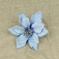 Blue artificial Christmas flower with silver glitter edges on beige linen background - Blue