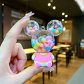 Cartoon liquid glitter bear keychain with colorful beads and pink mesh outfit - Iridescent