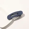 Detail shot of navy blue matte hair clip with hollow design on white ceramic plate - Matte Hair Clip Small - Royal Blue