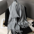 Detailed view of light gray cashmere-feel scarf with long tassels and elegant texture - Dark Gray