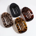 Flat lay of four leopard print and matte black oval hair claws for women's hair styling - Matte Black/Leopard Red Brown/Orange Yellow/Khaki