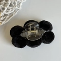 Detail of flower-shaped hair claw clip with black plush balls and gold metal spring - Black