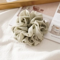Close-up of sage green chiffon scrunchie with delicate white pearl edge detail - Pleated Matcha