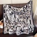 Detail of geometric floral silk-like scarf draped on leather background - 90*90cm / Black (XW-194)
