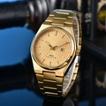Macro shot of gold stainless steel watch with checkered dial and calendar window - 14-Gold Waffle Dial