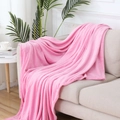 Pink solid color flannel fleece blanket draped over a beige sofa in a minimalist living room - Pink / 120x200cm