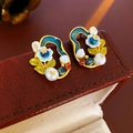 Macro shot of vintage flower earrings with freshwater pearls on a leather jewelry box - Green Enamel Crystal Pearl Flower Studs
