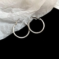 Detail view of silver twisted hoop earrings featuring polished finish and lever-back closure - 34# Flat Polished Silver Circle Hoop - 29mm
