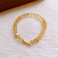 Elegant beaded bracelet with amber yellow beads and gold charms on white plush background - 13# Bracelet - Gold Yellow Fish