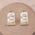 Macro shot of gold fortune tarot pendants with palm and eye mystic symbols on wood - Antique Gold FORTUNE