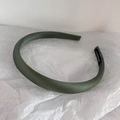 Detailed view of handmade dark green satin headband with silk luster and black label - Olive Green