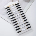 Detail of 12 black polymer clay bead bracelets with white CHEER letter beads and gold spacers - 12 Pieces / Black