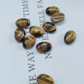 Macro shot of oval tiger eye stone cabochons with natural golden brown texture and luster - 6*8mm / Tiger Eye Stone Bracelet