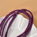 Strand of 2x4mm purple turquoise spacer beads for DIY jewelry making on white tray - Purple