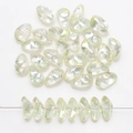 Macro view of iridescent petal-shaped glass beads showing pearlescent luster and texture - Crystal Yellow