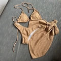 Detailed flat lay of three-piece camel bikini with rib texture and subtle polka dots - Coffee