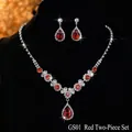 Exquisite close-up of a red crystal necklace and earring set on a black velvet display - GS01 Red Zircon Set / Red