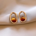 Detail of vintage leopard print earrings with gold frames on beige silk background - Oval Frame Amber Beaded Earrings (925 Sterling Silver Earring Post)
