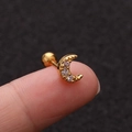 Macro shot of gold moon piercing stud with zircons on finger for size reference - Moon Gold - 1PC