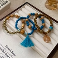 Bohemian multilayer beaded bracelet with tree of life charm and blue tassel detail - Tree of Life Wood Bead 4-Layer Bracelet